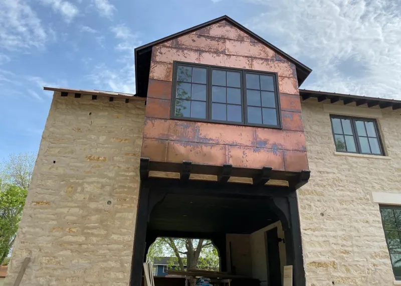 Copper metal panel facade on a stone building for Roof Repair in Holly Ridge