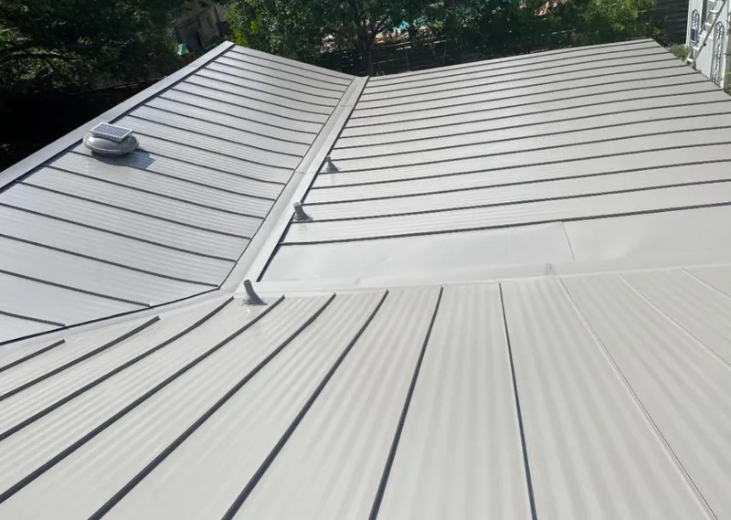 Solar attic fan installed on a metal roof for Roof Ventilation in Holly Ridge